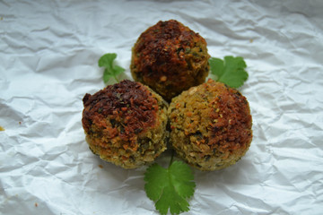 Falafel on white paper. vegan food on a white background. fresh vegan tasty falafel with spices, falafel baked in the oven. chickpeas balls. a source of protein for vegans. 