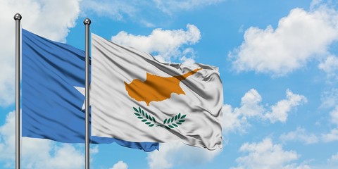 Somalia and Cyprus flag waving in the wind against white cloudy blue sky together. Diplomacy...