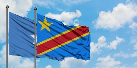 Somalia and Congo flag waving in the wind against white cloudy blue sky together. Diplomacy...