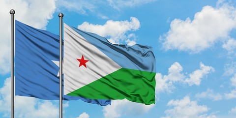 Somalia and Djibouti flag waving in the wind against white cloudy blue sky together. Diplomacy concept, international relations.