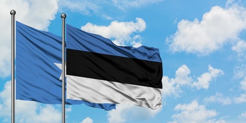 Somalia and Estonia flag waving in the wind against white cloudy blue sky together. Diplomacy concept, international relations.