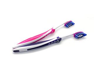 Purple and pink toothbrushes isolated on a white background. Toothbrushes for health care. Professional toothbrushes.