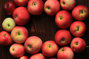 red apples in a basket of willow. red apples on a wooden table