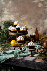 Fototapeta na wymiar lemon cupcakes with whipped meringue on wooden cake stands 