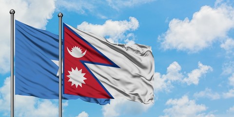 Somalia and Nepal flag waving in the wind against white cloudy blue sky together. Diplomacy concept, international relations.