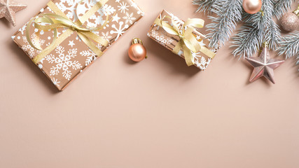 Christmas frame top border of gifts, fir tree branch, Xmas balls and star on copper background....