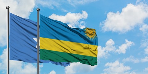Somalia and Rwanda flag waving in the wind against white cloudy blue sky together. Diplomacy concept, international relations.