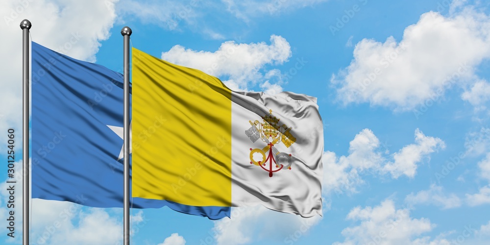 Wall mural somalia and vatican city flag waving in the wind against white cloudy blue sky together. diplomacy c