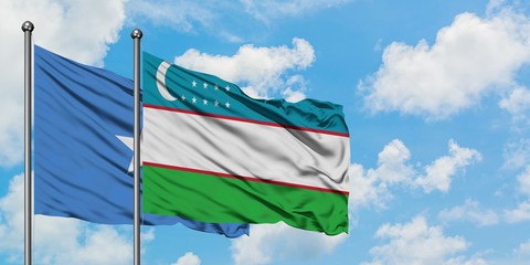 Somalia and Uzbekistan flag waving in the wind against white cloudy blue sky together. Diplomacy concept, international relations.
