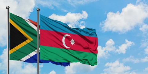 South Africa and Azerbaijan flag waving in the wind against white cloudy blue sky together. Diplomacy concept, international relations.