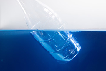 Plastic bottle floating in water. Concept save the world.