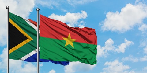 South Africa and Burkina Faso flag waving in the wind against white cloudy blue sky together. Diplomacy concept, international relations.