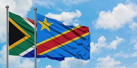 South Africa and Congo flag waving in the wind against white cloudy blue sky together. Diplomacy concept, international relations.