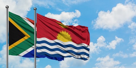 South Africa and Kiribati flag waving in the wind against white cloudy blue sky together. Diplomacy concept, international relations.