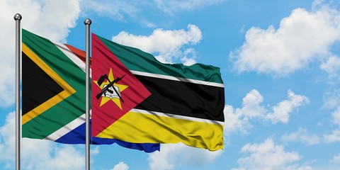 South Africa and Mozambique flag waving in the wind against white cloudy blue sky together. Diplomacy concept, international relations.