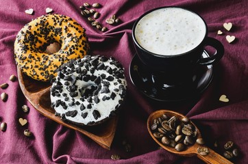 Elegant concept of serving coffee. Coffee with colorful croissants on a dark background.