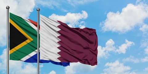 South Africa and Qatar flag waving in the wind against white cloudy blue sky together. Diplomacy concept, international relations.