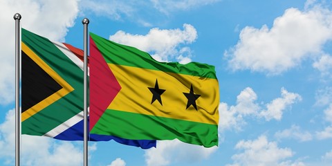 South Africa and Sao Tome And Principe flag waving in the wind against white cloudy blue sky together. Diplomacy concept, international relations.
