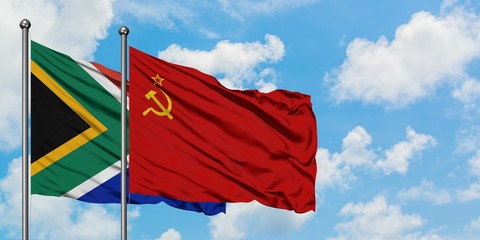 South Africa and Soviet Union flag waving in the wind against white cloudy blue sky together. Diplomacy concept, international relations.