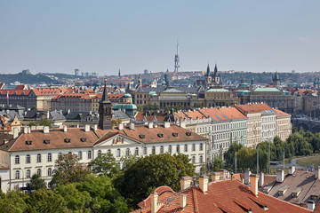 Fototapeta na wymiar View of the roofs of red tiles and other buildings in Prague, the Czech Republic.