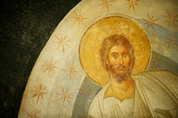 Close up of ancient Byzantine mosaic of Jesus Christ with a golden halo