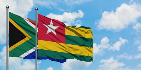 South Africa and Togo flag waving in the wind against white cloudy blue sky together. Diplomacy concept, international relations.