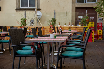 Fototapeta na wymiar Tables with tablecloths and chairs on the terrace in a cafe in Prague, the Czech Republic.