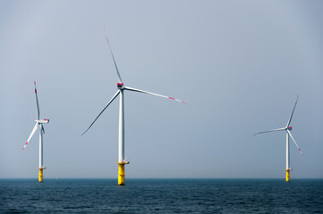 Offshore wind farm with three wind mills in the north sea.