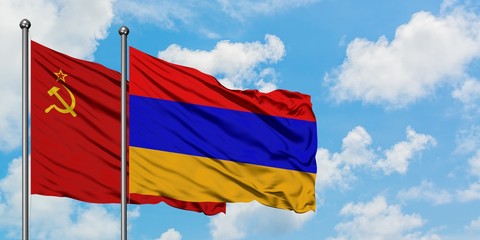 Soviet Union and Armenia flag waving in the wind against white cloudy blue sky together. Diplomacy concept, international relations.