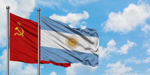 Soviet Union and Argentina flag waving in the wind against white cloudy blue sky together. Diplomacy concept, international relations.