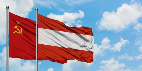 Soviet Union and Austria flag waving in the wind against white cloudy blue sky together. Diplomacy concept, international relations.
