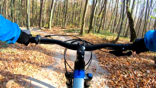 Amateur rider on the enduro bike riding on the trail in the autumn season