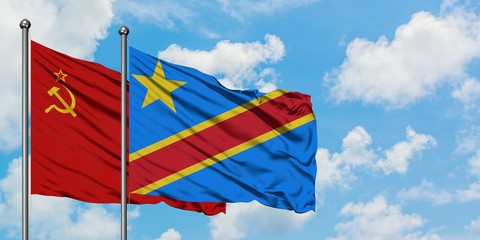 Soviet Union and Congo flag waving in the wind against white cloudy blue sky together. Diplomacy...