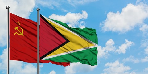 Soviet Union and Guyana flag waving in the wind against white cloudy blue sky together. Diplomacy concept, international relations.
