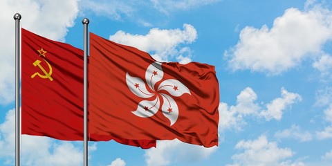 Soviet Union and Hong Kong flag waving in the wind against white cloudy blue sky together. Diplomacy concept, international relations.