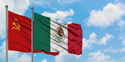 Soviet Union and Mexico flag waving in the wind against white cloudy blue sky together. Diplomacy concept, international relations.