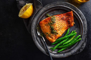 Closeup of baked salmon fish with green beans