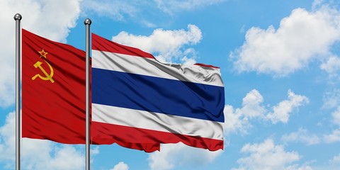 Soviet Union and Thailand flag waving in the wind against white cloudy blue sky together. Diplomacy concept, international relations.