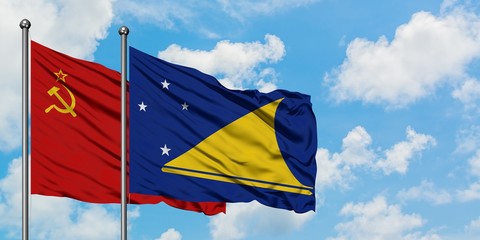 Soviet Union and Tokelau flag waving in the wind against white cloudy blue sky together. Diplomacy concept, international relations.