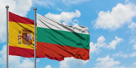 Spain and Bulgaria flag waving in the wind against white cloudy blue sky together. Diplomacy concept, international relations.