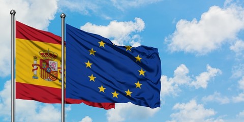 Spain and European Union flag waving in the wind against white cloudy blue sky together. Diplomacy concept, international relations.