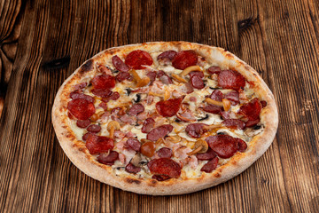 Side view of italian seasonal pizza with wild mushrooms and spicy pepperoni