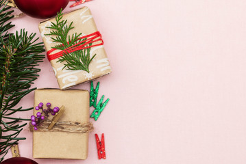 handmade beautiful christmas background with gift and fir branch, a pink background