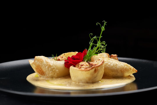 Italian pasta Conkiglioni with meat and mushrooms