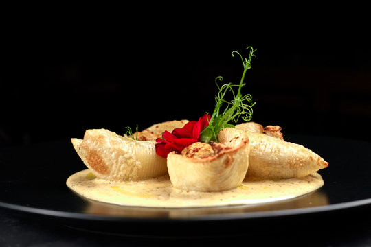 Italian pasta Conkiglioni with meat and mushrooms