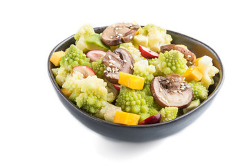 Vegetarian salad from romanesco cabbage, champignons, cranberry, avocado and pumpkin isolated on a white background. side view.