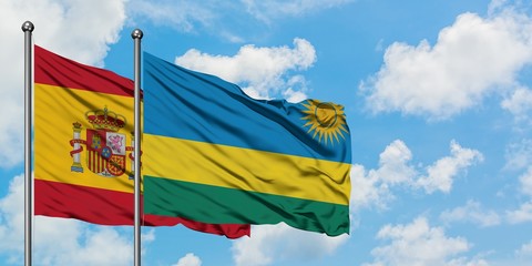 Spain and Rwanda flag waving in the wind against white cloudy blue sky together. Diplomacy concept,...