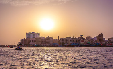 Fototapeta premium DUBAI, UAE-MAY17: Traditional Abra ferries along Dubai Creek. The Creek divides the city into two main sections: Deira and Bur Dubai..