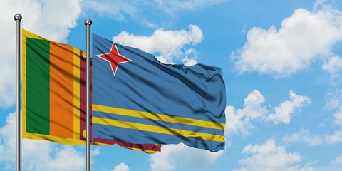Sri Lanka and Aruba flag waving in the wind against white cloudy blue sky together. Diplomacy concept, international relations.