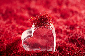 saffron threads background with glass heart